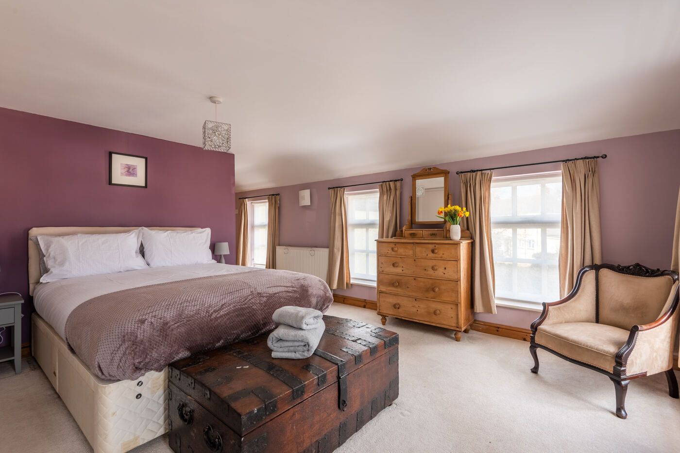 Master bedroom with king-size bed and antique chest